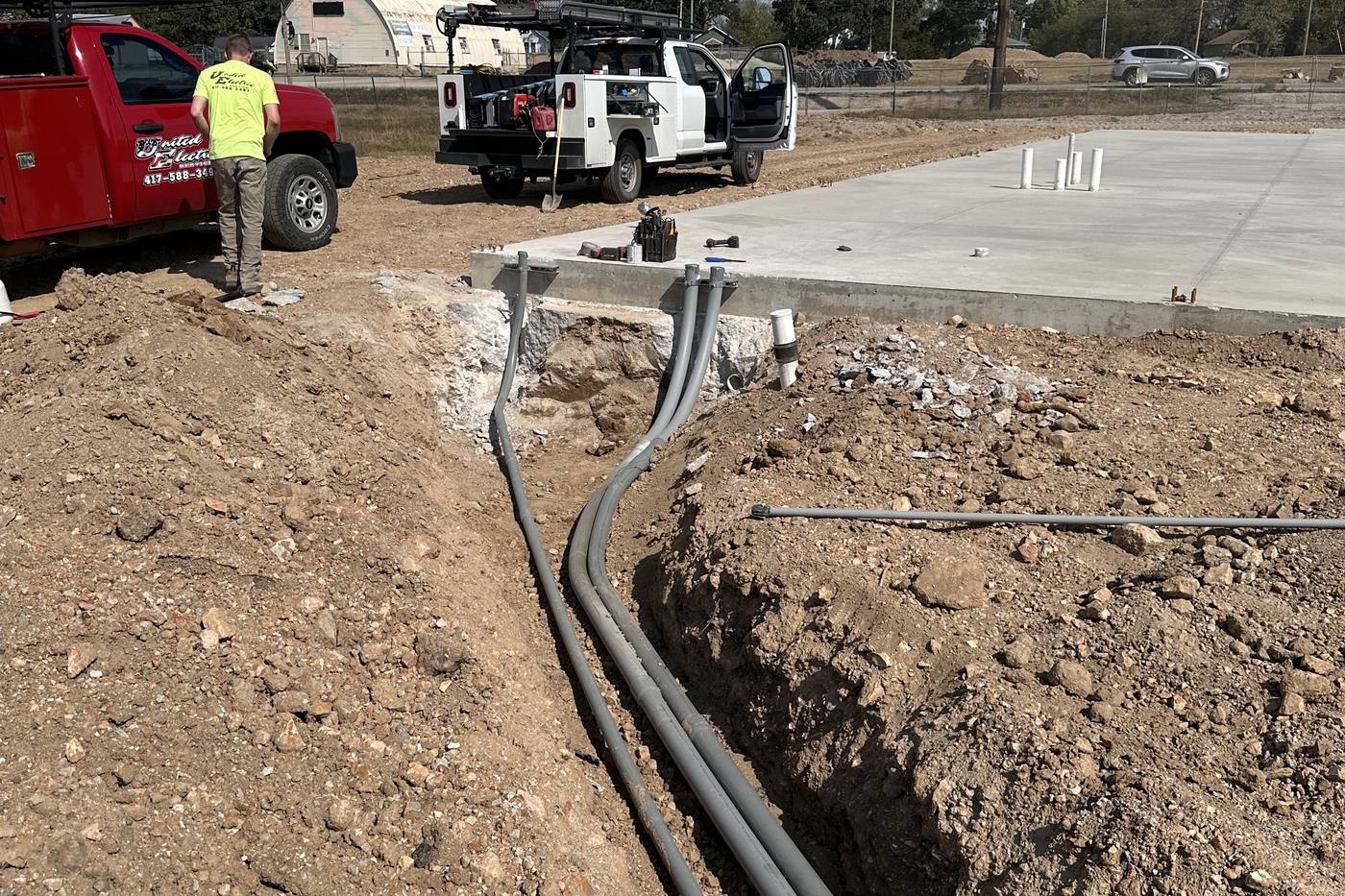 Underground conduit runs trenched into a new commercial slab